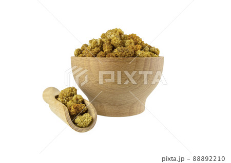 dried white mulberry fruit - latin Morus alba -  in wooden bowl and scoop isolated on white background. Spices and food ingredients. 88892210