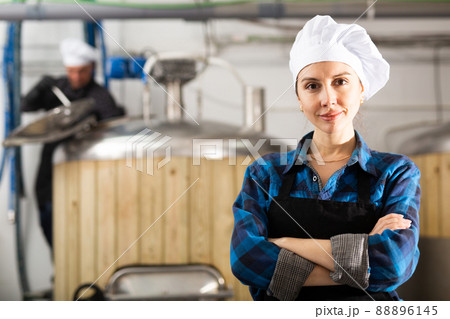 Portrait woman brewer standing in workshop of beer factory 88896145