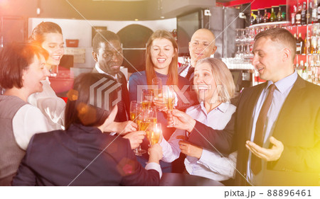 Colleagues clinking glasses of champagne on corporate party Colleagues clinking glasses of champagne on corporate party 88896461
