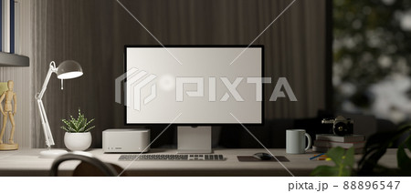 Home office workspace in the evening close-up, with computer mockup Home office workspace in the evening close-up, with computer mockup 88896547