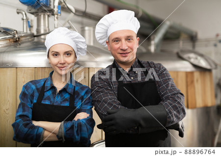 Portrait of man and woman brewmasters in beer factory 88896764