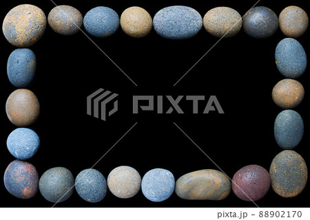 A frame of coloured pebbles on a black background A frame of coloured pebbles on a black background 88902170