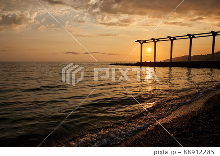 Sea pier against the background of the sunset sky 88912285