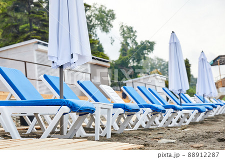 Sun loungers with blue mattresses on the beach Sun loungers with blue mattresses on the beach 88912287
