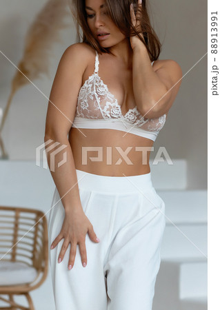 Seductive female taking off pajama pants 88913991