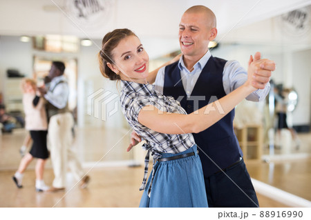 Happy man and woman enjoying ballroom dancing Happy man and woman enjoying ballroom dancing 88916990