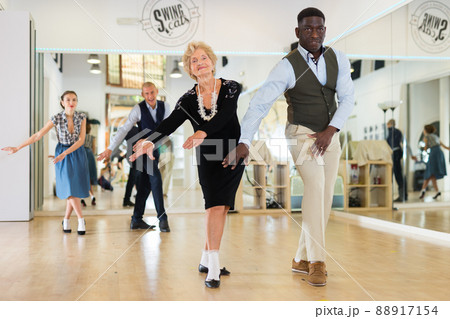 Senior womaSenior woman and man dancing swing in studion and man dancing swing in studio 88917154