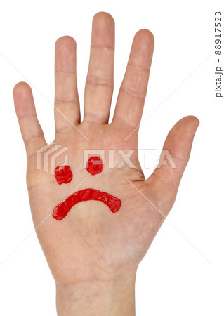 Sad smiley drawn on child hand Sad smiley drawn on child hand 88917523