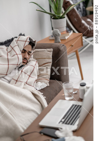 A sick man lying in bed and napping A sick man lying in bed and napping 88919492