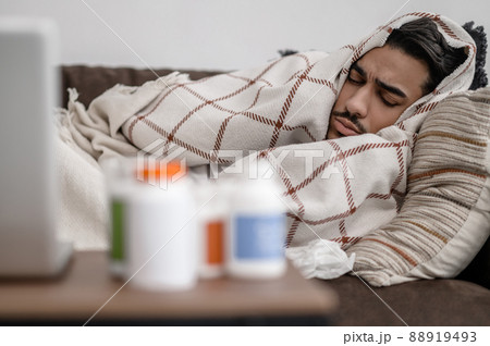 A sick man lying in bed and napping A sick man lying in bed and napping 88919493