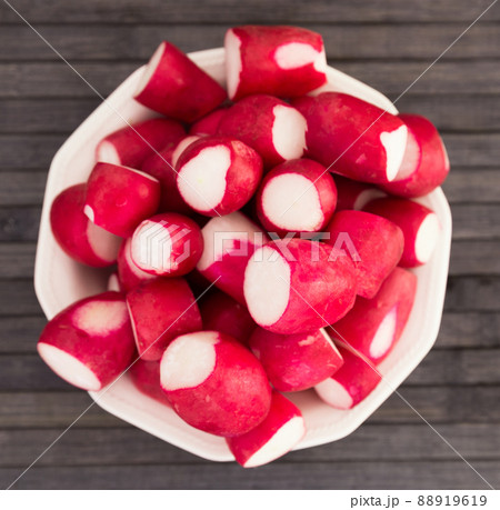 cooked crispy radish in white bowl on wooden table 88919619