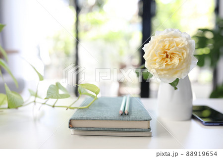 Notebook and vase of rose 88919654