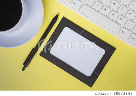 Directly above view of office desk table with yellow background. Copy space. 88923345