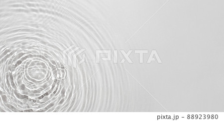 The texture of water on a gray background in bright sunlight. 88923980