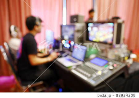 Blur people working at outside broadcasting switcher 88924209
