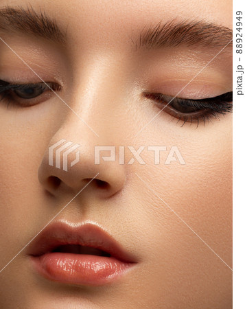 Closeup of beauty woman with clean shiny skin and natural cosmetics. Beautiful extrem eyelash and plump lips of a well-groomed girl demonstrate spa procedures, injections in a beauty parlor Closeup of beauty woman with clean shiny skin and natural cosmetics. Beautiful extrem eyelash and plump lips of a well-groomed girl demonstrate spa procedures, injections in a beauty parlor 88924949