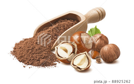 Hazelnuts and wooden scoop with cocoa powder isolated on white background. 88925262