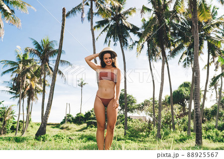 Joyful young woman enjoying summer day at tropical resort 88925567