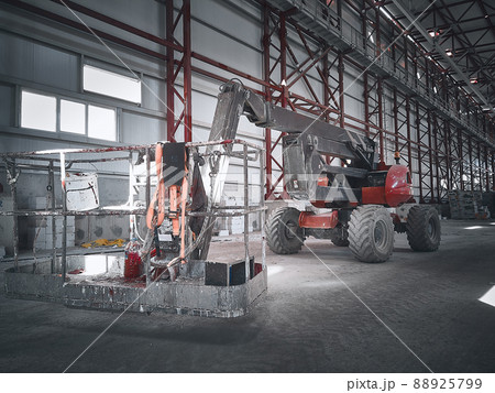 Basket of boom lift picker inside industrial building Basket of boom lift picker inside industrial building 88925799
