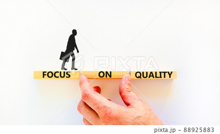 Focus on quality symbol. Concept words Focus on quality on blocks on beautiful white table white background. Businessman hand. Business, focus on quality concept. Copy space. 88925883