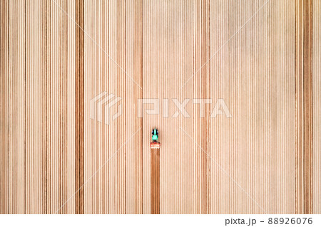 Lonely tractor on agricultural field with rows of plowed soil 88926076