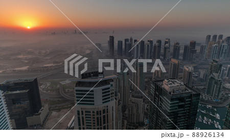 Panorama of Dubai Marina with JLT skyscrapers and golf course during sunrise timelapse, Dubai, United Arab Emirates. Panorama of Dubai Marina with JLT skyscrapers and golf course during sunrise timelapse, Dubai, United Arab Emirates. 88926134