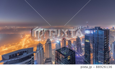 Panorama of Dubai Marina with JLT skyscrapers and golf course night to day timelapse, Dubai, United Arab Emirates. 88926136