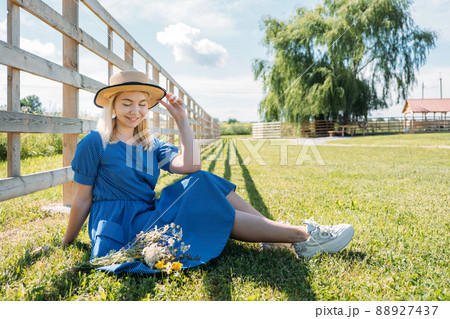 Agritourism and Farm Tours, Farm Cottagecore Weekend Trip. Farm Trips For Peaceful Weekend. A woman in rustic dress and with wildflowers in front of straw bales Agritourism and Farm Tours, Farm Cottagecore Weekend Trip. Farm Trips For Peaceful Weekend. A woman in rustic dress and with wildflowers in front of straw bales 88927437