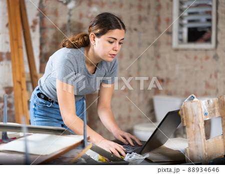 Woman with laptop on indoor construction site 88934646