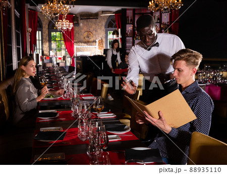 Man holding menu and ordering food 88935110