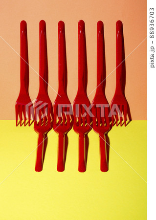 Abstract still life with red forks on a colored background Abstract still life with red forks on a colored background 88936703