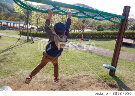公園の変わった形の雲梯で遊ぶ男の子 公園の変わった形の雲梯で遊ぶ男の子 88937950
