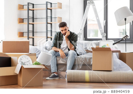 sad man with boxes moving to new home 88940459