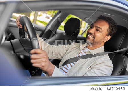 smiling indian man or driver driving car 88940486