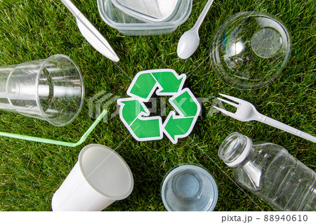 green recycling sign and plastic waste on grass green recycling sign and plastic waste on grass 88940610