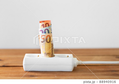 close up of money inside electric socket 88940916