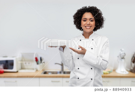 happy smiling female chef holding empty plate happy smiling female chef holding empty plate 88940933