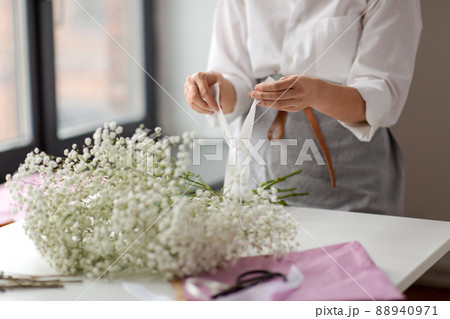 woman or floral artist making flower bunch 88940971