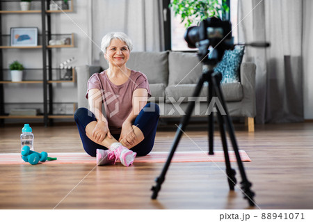 woman or fitness blogger with camera at home woman or fitness blogger with camera at home 88941071