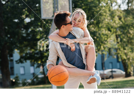 happy couple having fun on basketball playground 88941122