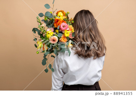woman with bunch of flowers from back woman with bunch of flowers from back 88941355