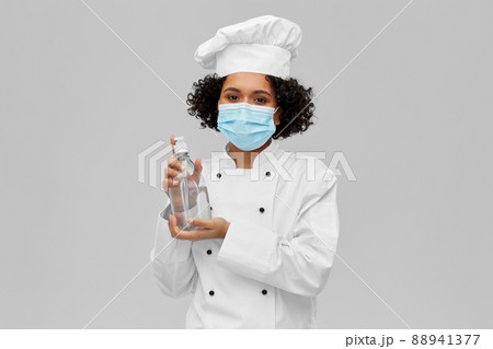 female chef in mask with hand sanitizer or soap female chef in mask with hand sanitizer or soap 88941377