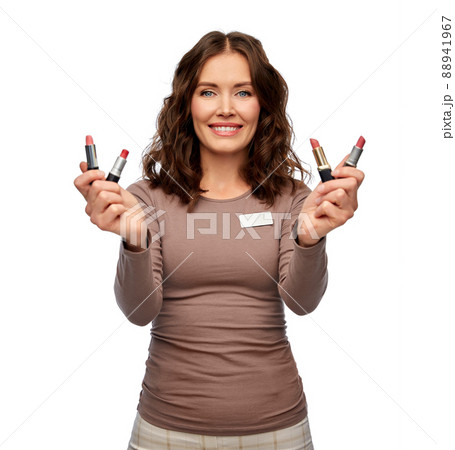smiling saleswoman or makeup artist with lipsticks 88941967