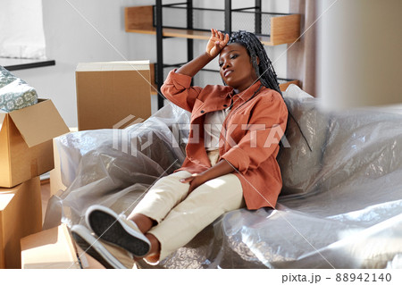 tired woman with boxes moving to new home tired woman with boxes moving to new home 88942140