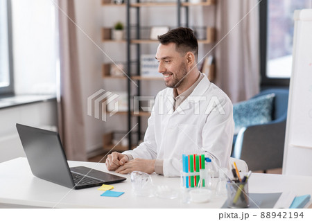 chemistry teacher with laptop having online class 88942194