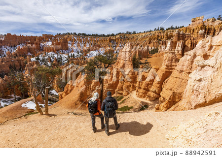 United States, Utah, Bryce Canyon National Park, Senior hiker couple exploring Bryce Canyon National Park 88942591