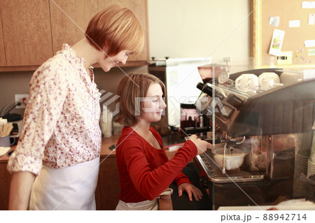 Owner and daughter (10-11) in small bakery 88942714