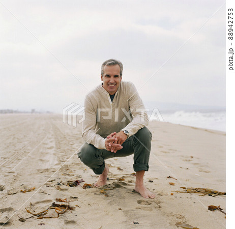 Portrait of man relaxing on beach Portrait of man relaxing on beach 88942753