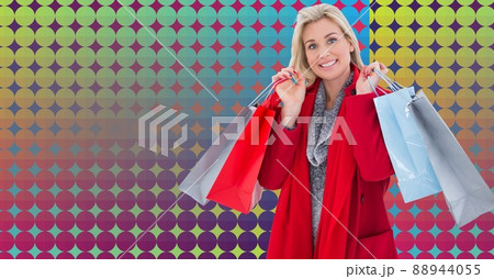 Portrait of caucasian woman holding shopping bags against colorful background with copy space Portrait of caucasian woman holding shopping bags against colorful background with copy space 88944055