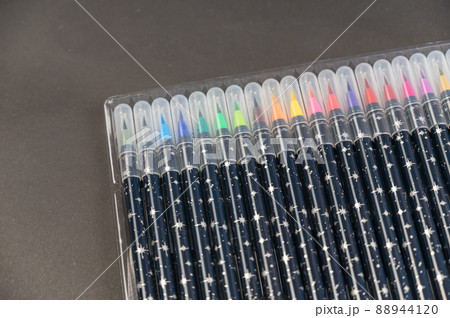 Set of watercolor markers in a pack against a black background. Multicolored markers for drawing on paper. Creativity, learning to draw concept. Set of watercolor markers in a pack against a black background. Multicolored markers for drawing on paper. Creativity, learning to draw concept. 88944120